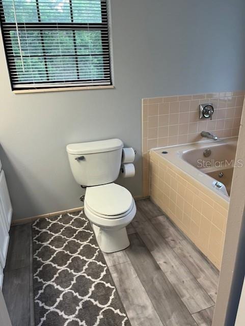 10245 SW 105th St, Ocala, FL 34481 - bathroom featuring a jetted tub, toilet, wood finished floors, and baseboards