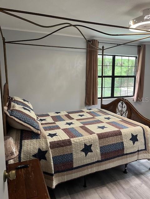 10245 SW 105th St, Ocala, FL 34481 - bedroom featuring wood finished floors and crown molding