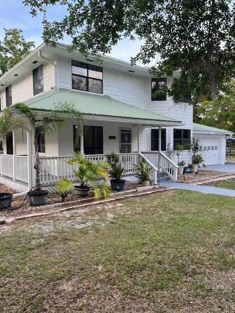 10245 SW 105th St, Ocala, FL 34481 - view of front of house featuring covered porch, a garage, and a front lawn