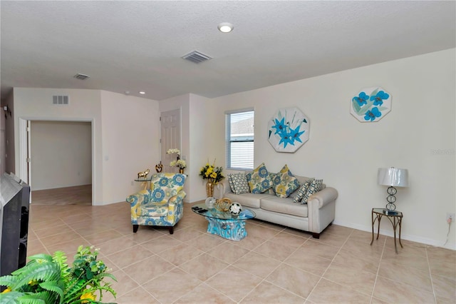 living room featuring light tile patterned floors and a textured ceiling