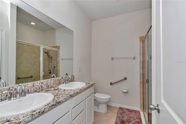 bathroom featuring tile patterned flooring, an enclosed shower, vanity, and toilet