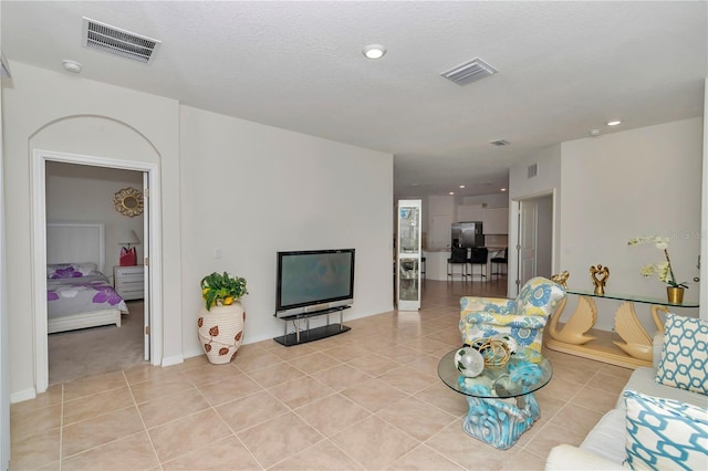 tiled living room with a textured ceiling