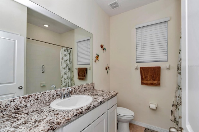 bathroom featuring vanity, curtained shower, tile patterned floors, and toilet