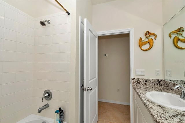 bathroom with tiled shower / bath, tile patterned floors, and vanity