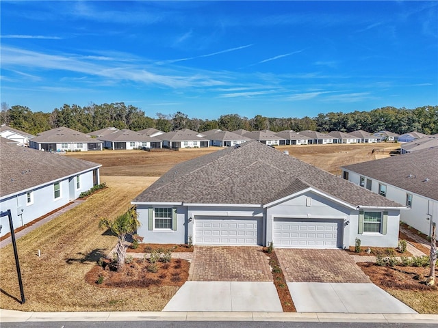 view of front of home featuring a garage and a front lawn