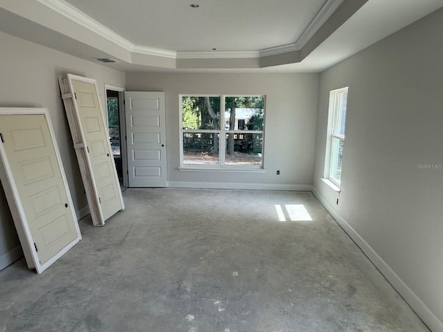 13 NW 45th Loop, Ocala, FL 34475 - spare room with a tray ceiling, ornamental molding, concrete floors, and baseboards