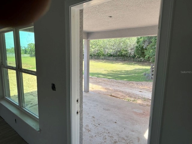 13 NW 45th Loop, Ocala, FL 34475 - doorway to outside with a textured ceiling