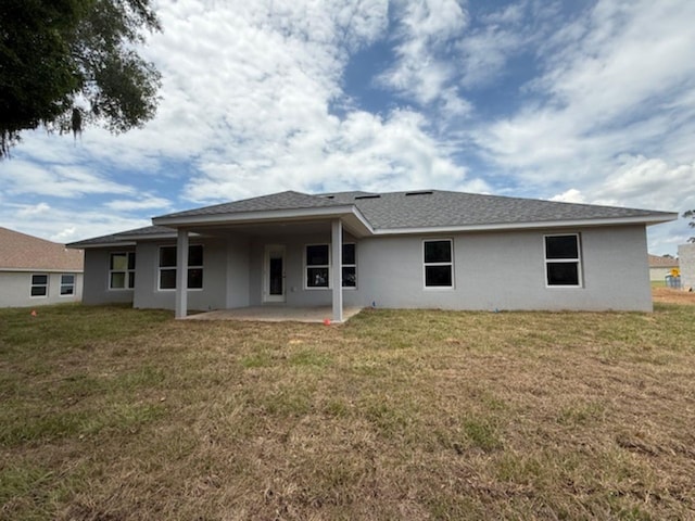 13 NW 45th Loop, Ocala, FL 34475 - back of house with a patio area, stucco siding, and a lawn