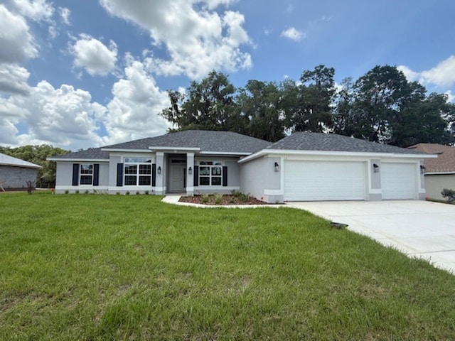13 NW 45th Loop, Ocala, FL 34475 - view of front of house featuring a garage, driveway, a front yard, and stucco siding
