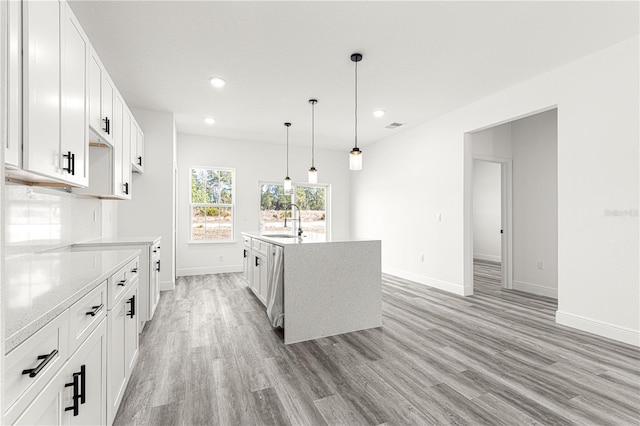 kitchen featuring white cabinetry, sink, and pendant lighting