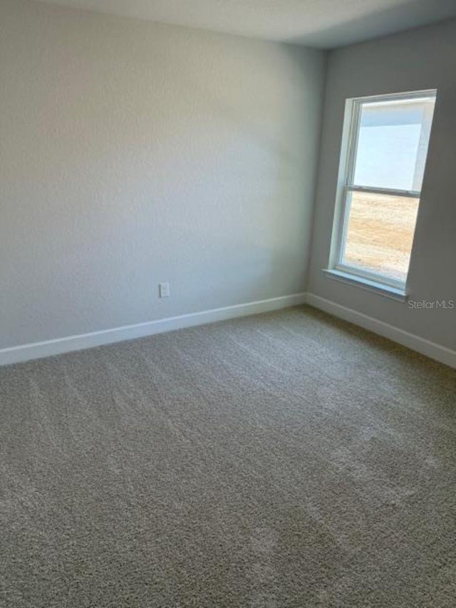 7 NW 45th Loop, Ocala, FL 34470 - empty room with baseboards and carpet flooring