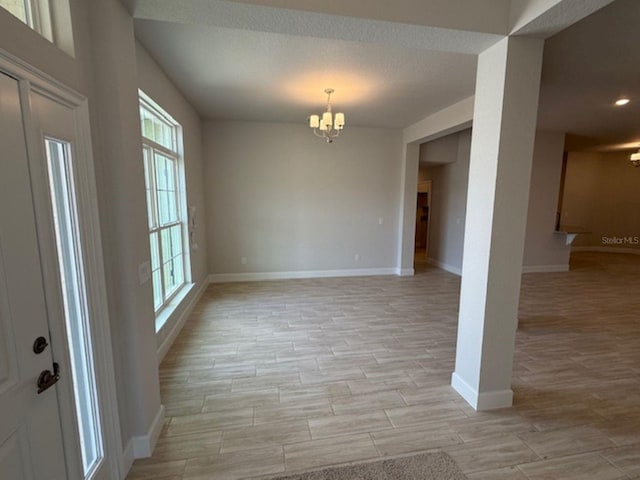 7 NW 45th Loop, Ocala, FL 34470 - unfurnished dining area featuring a chandelier, healthy amount of natural light, baseboards, light wood-style floors, and recessed lighting