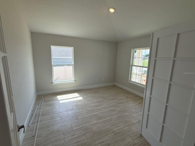 7 NW 45th Loop, Ocala, FL 34470 - empty room with baseboards and light wood-style floors