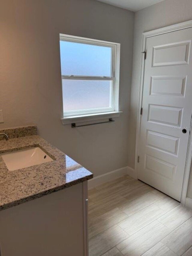 7 NW 45th Loop, Ocala, FL 34470 - bathroom with vanity and baseboards