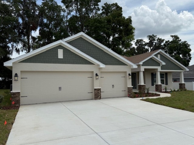 7 NW 45th Loop, Ocala, FL 34470 - craftsman-style home with stone siding, driveway, and an attached garage