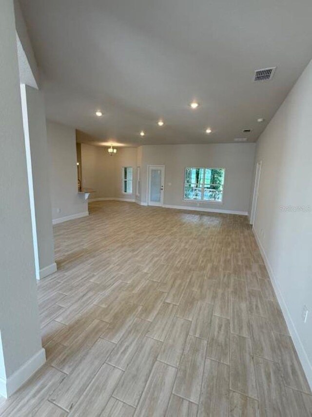 7 NW 45th Loop, Ocala, FL 34470 - unfurnished living room with light wood-type flooring, baseboards, and recessed lighting