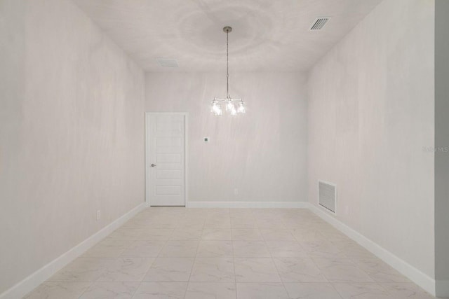 spare room featuring a notable chandelier