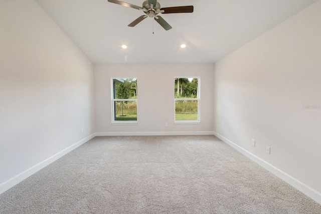 carpeted spare room with lofted ceiling and ceiling fan