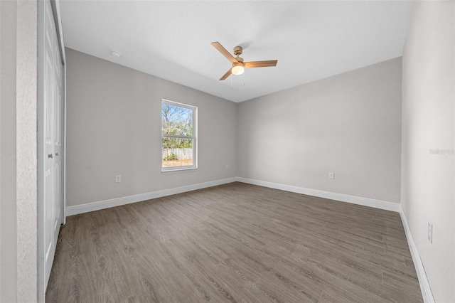 interior space featuring dark wood-type flooring and ceiling fan