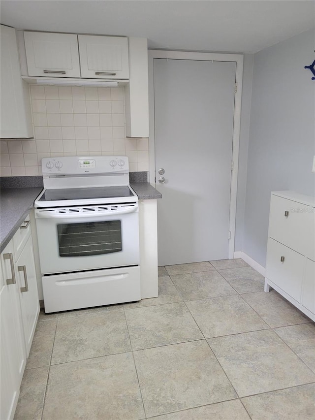 kitchen featuring electric stove, white cabinetry, light tile patterned floors, and backsplash