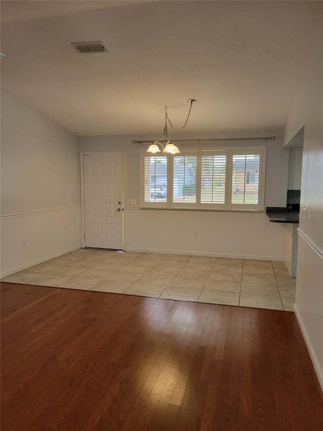 unfurnished dining area featuring light wood-type flooring