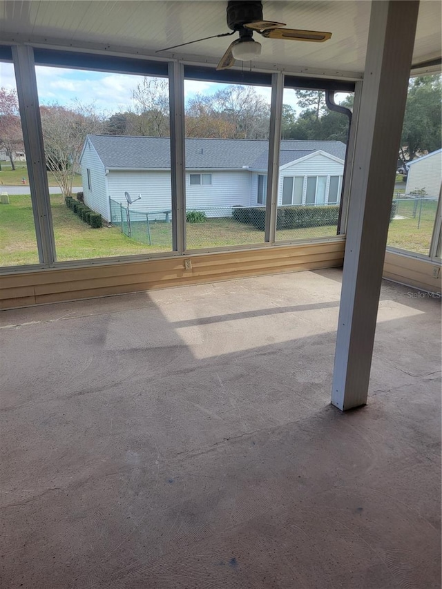 unfurnished sunroom featuring ceiling fan