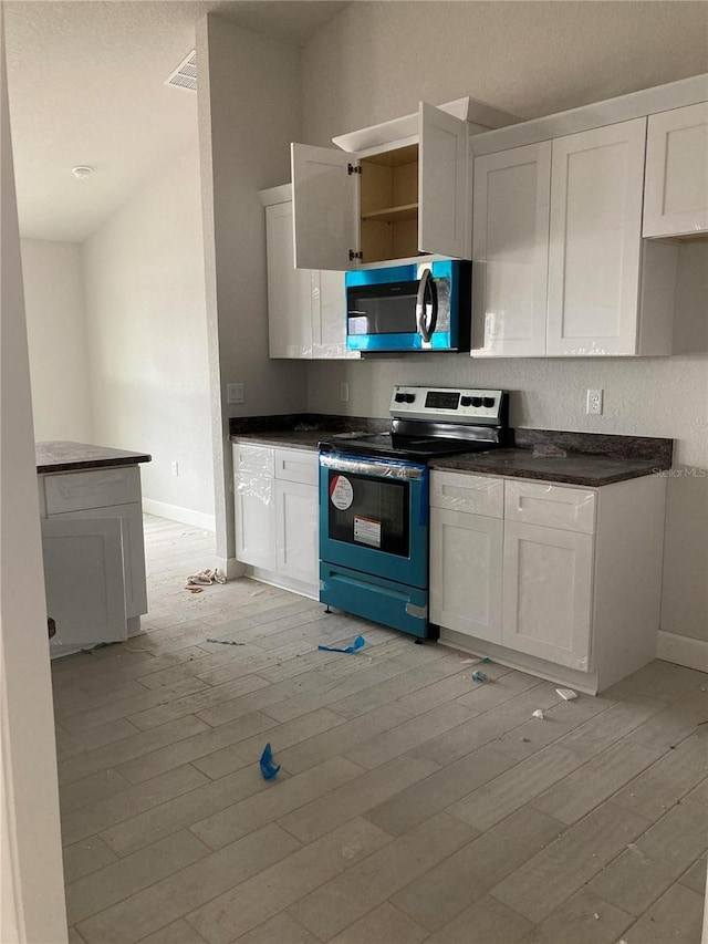 kitchen with white cabinetry, stainless steel electric stove, and light hardwood / wood-style flooring