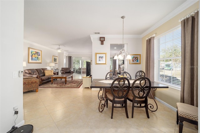 dining room featuring crown molding, ceiling fan, and light tile patterned floors