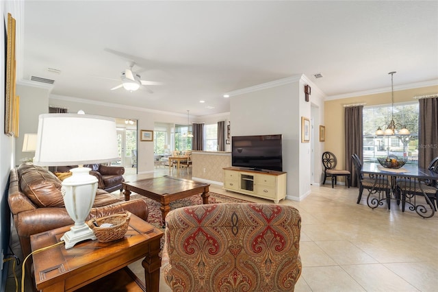 tiled living room featuring ornamental molding and ceiling fan with notable chandelier