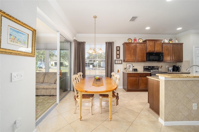 kitchen with crown molding, decorative light fixtures, light stone counters, and electric stove