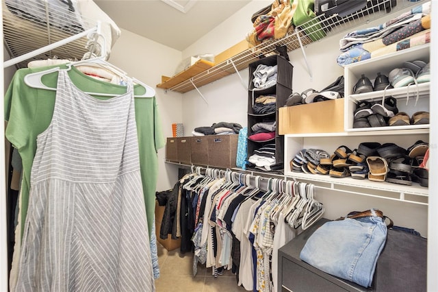 walk in closet with tile patterned floors