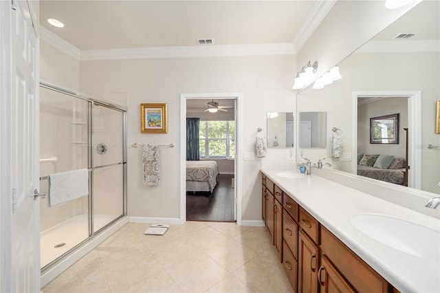 bathroom with tile patterned flooring, crown molding, vanity, and a shower with shower door