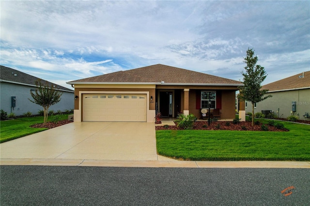 view of front of house featuring a garage and a front lawn