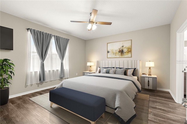 bedroom with ceiling fan and dark hardwood / wood-style floors