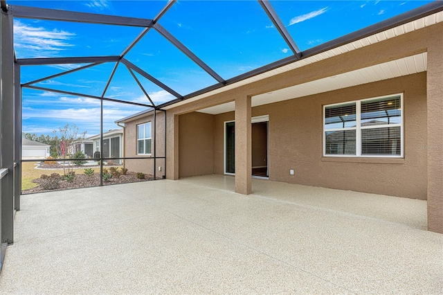 view of patio featuring glass enclosure