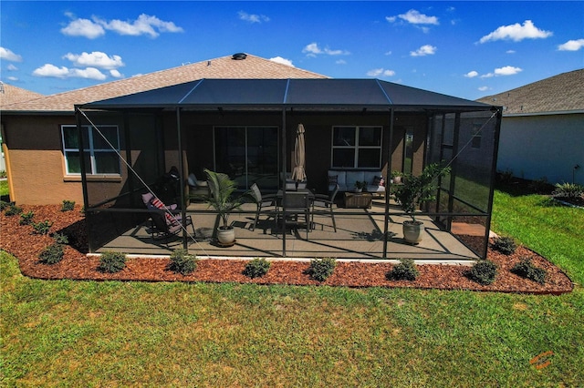 back of house with a yard, a lanai, and a patio area