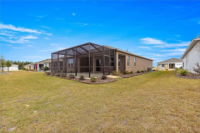 back of house with a garage, a yard, and central AC unit