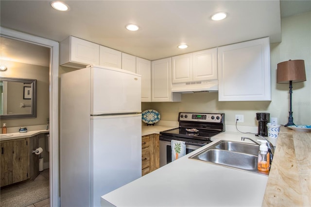 kitchen with white cabinetry, sink, stainless steel electric range, and white refrigerator