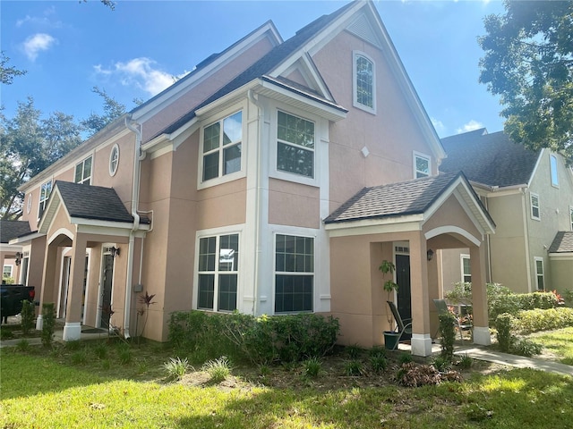 rear view of property featuring a lawn