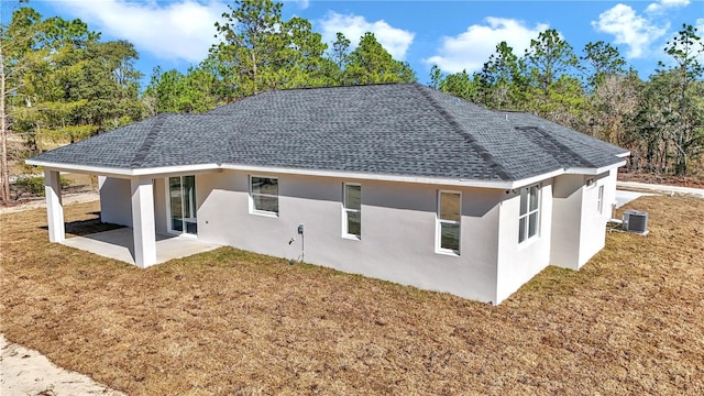 back of property featuring a patio, cooling unit, and a lawn