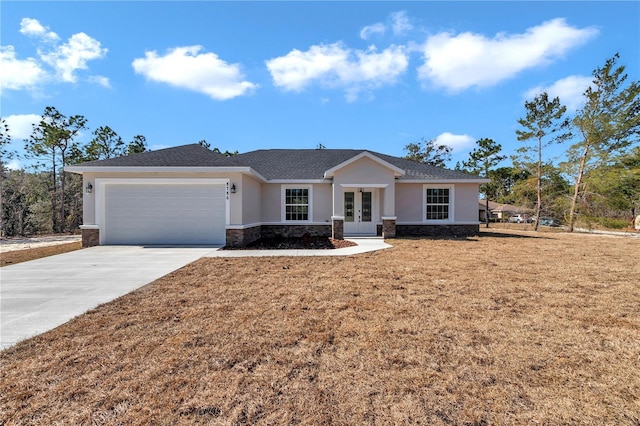 ranch-style house featuring a garage and a front lawn