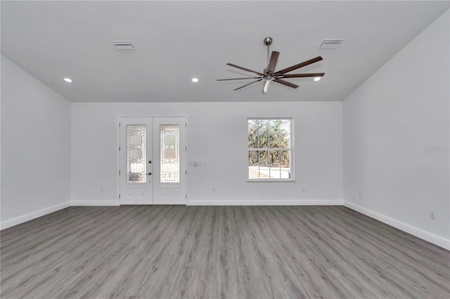 unfurnished room with french doors, ceiling fan, vaulted ceiling, and light wood-type flooring