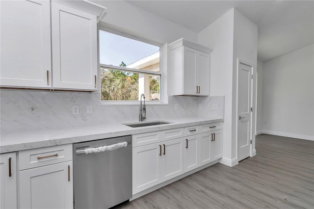 kitchen with dishwasher, sink, white cabinets, and backsplash