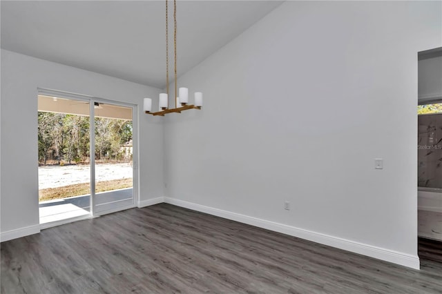 unfurnished dining area with lofted ceiling, dark wood-type flooring, and a notable chandelier