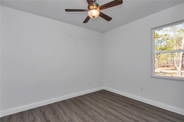 unfurnished room with dark hardwood / wood-style flooring and ceiling fan