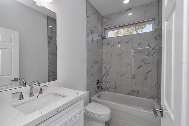 full bathroom with vanity, toilet, and tiled shower / bath combo