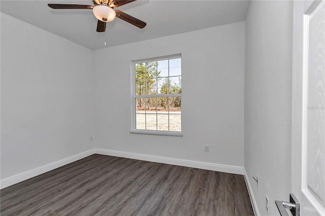 spare room featuring dark hardwood / wood-style floors and ceiling fan