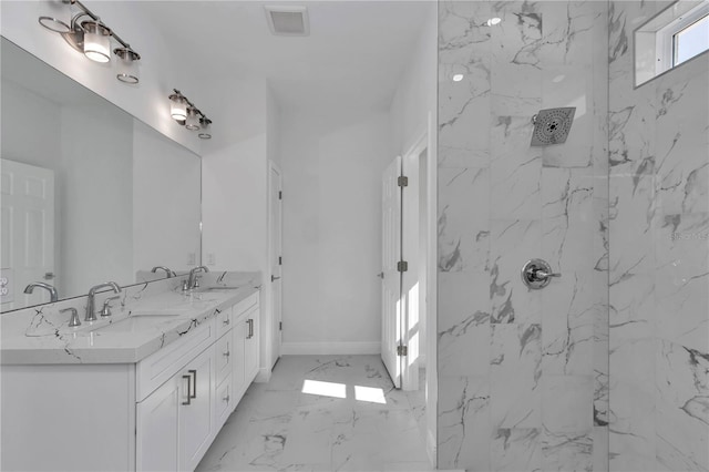 bathroom with tiled shower and vanity