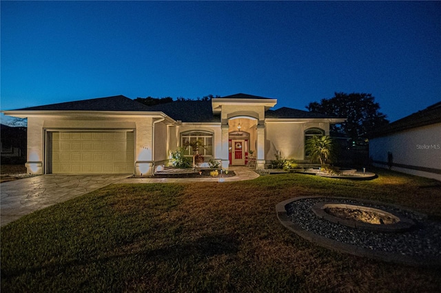 view of front of house featuring a garage and a front lawn