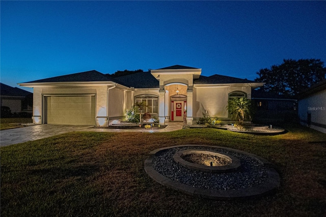 view of front of house with a garage and a front yard